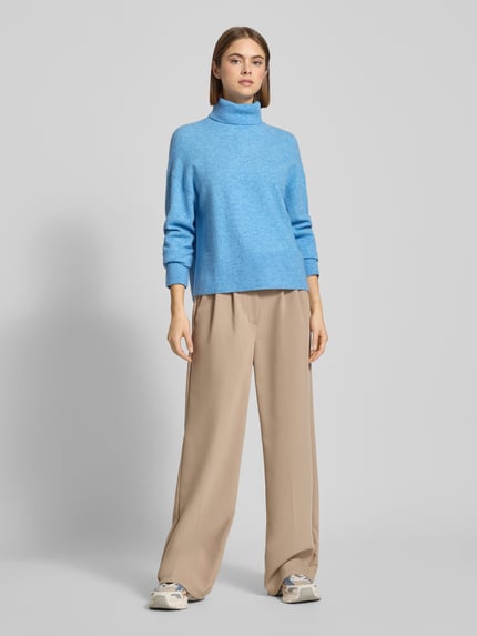 Frauenmodel trägt Regular Fit Rollkragenpullover aus Schurwoll-Mix von Marc O'Polo Denim in Melange-Strick, hellblau, Ganzkörperansicht von vorne.