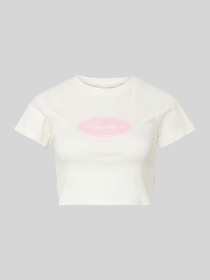Produktfoto, Cropped T-Shirt mit Logo-Print von Another Cotton Lab, damski t-shirt z bawełny, krój krótki, nadruk z logo, okrągły dekolt, długość tyłu w rozmiarze S: 36 cm