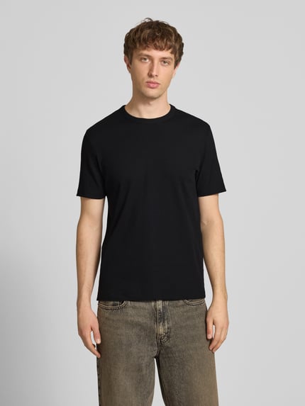 Männermodel trägt Regular Fit T-Shirt aus Baumwoll-Mix von Marc O’Polo Denim in Schwarz, unifarben, Rundhals, kurzarm, Ganzkörperansicht von vorne.