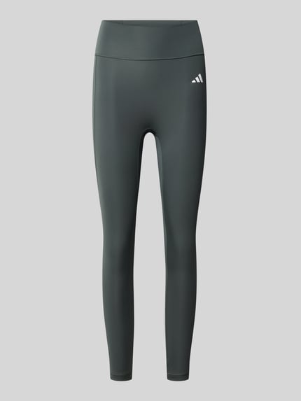Produktfoto, Eng anliegende Sport-Leggings mit Gesäßtasche von adidas Training in Dunkelgrau mit glatter Struktur, neutraler Hintergrund.