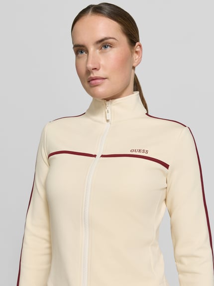 Kobiece model prezentuje Slim Fit Sweatjacke mit Stehkragen Modell 'Jasmine' od Guess Activewear, kremowy kolor z bordowymi akcentami, krój slim fit, elastyczny materiał z bawełną i logo, zbliżenie na górną część ciała