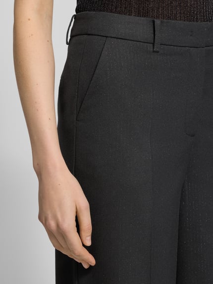 Kobiece modelka nosi Stoffhose mit Gesäßtaschen od More & More, czarny materiał z domieszką wiskozy, luźny krój, zbliżenie na górną część spodni, widok z przodu.