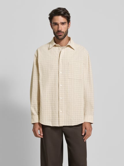 Männermodel trägt Freizeithemd mit Knopfleiste Modell 'Carter' van Wood Wood, beige met ruitpatroon, katoenmix, losse snit, Ganzkörperansicht von vorne.