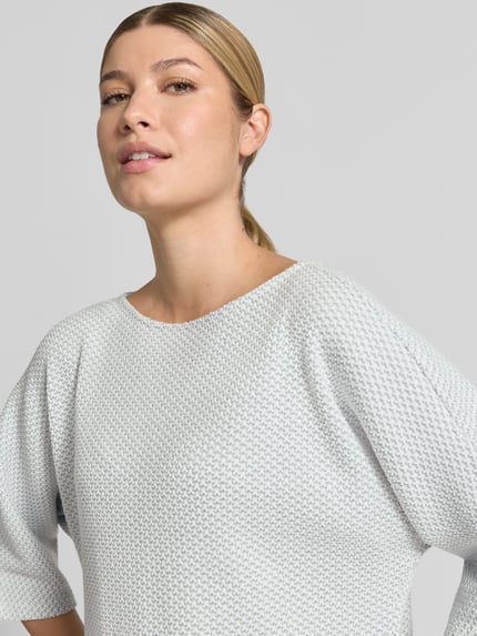 Frauenmodel trägt Loose Fit Pullover mit Baumwoll-Anteil Modell 'Sassoni' von OPUS, feine Struktur, hellgraue Farbe, Nahaufnahme Oberkörper. Damen Pullover von OPUS.