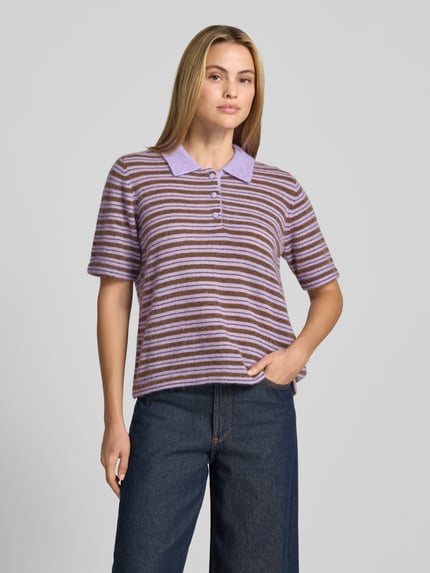 Frauenmodel trägt Poloshirt mit Woll-Anteil Modell 'Milvi' von MOS MOSH, lilafarbene und braune Streifen, figurbetonter Schnitt, Nahaufnahme Oberkörper. Taillierte Passform, Polokragen, Label-Detail, Rückenlänge bei Größe S: 59 cm, Ärmellänge bei Größe S: 27 cm, Material-Mix mit Woll-Anteil.