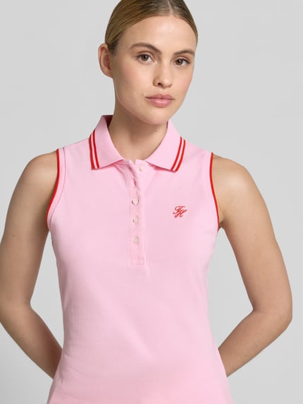 Frauenmodel trägt Slim Fit Poloshirt aus Baumwoll-Mix von Tommy Hilfiger in Two-Tone-Optik mit Logo-Stitching und Kontrast-Nähten, Nahaufnahme Oberkörper.