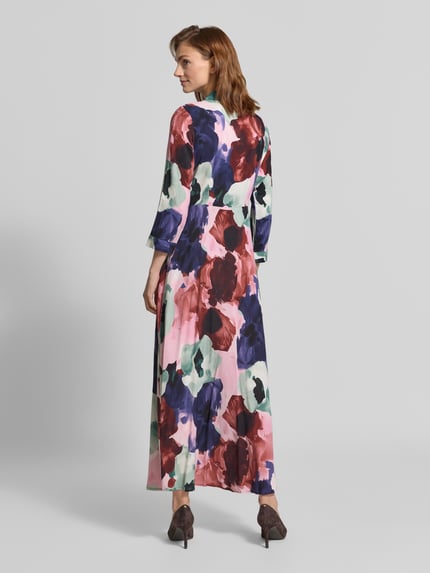 Vrouwenmodel draagt overhemdjurk uit zuiver viscose met kleurrijke bloemenprint, getailleerd model, 3/4-mouw, Model 'SAVANNA' van YAS, Maxi-jurk, knoopsluiting, overhemdkraag, ruglengte maat S 139 cm, borstwijdte 45 cm, mouwlengte 49 cm, geheelopname achterkant