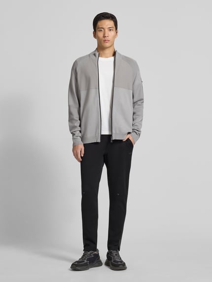Męski model nosi Regular Fit Sweatpants aus schnell trocknenden Material Modell 'HICON ACTIVE' von BOSS Green, jednokolorowy efekt, nadruk z logo, elastyczny ściągacz, wpuszczane kieszenie boczne, kieszeń z tyłu, flatlockowe szwy, widok całej sylwetki z przodu.