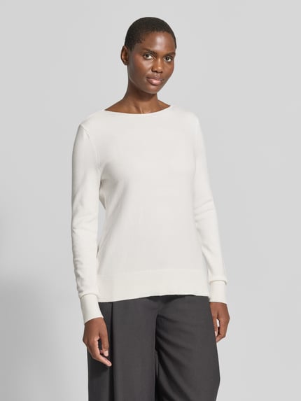 Frauenmodel trägt Regular Fit Strickpullover aus Viskose-Mix mit U-Boot-Ausschnitt von Christian Berg Woman, weiß, glatte Textur, langärmliges Design, gerippte Abschlüsse, überschnittene Schultern, Ganzkörperansicht von vorne.