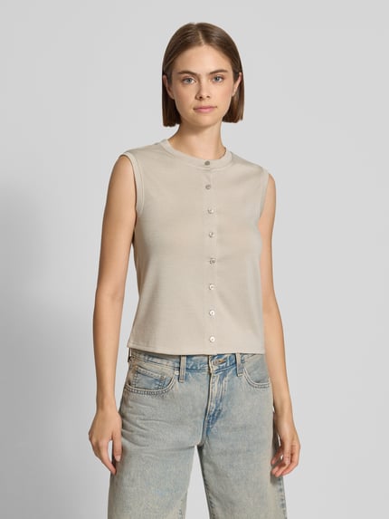Frauenmodel trägt Regular Fit Top mit Viskose-Anteil Modell 'PIMI' von PIECES in Beige, glatte Textur, silberne Knöpfe, Damen Top, Ganzkörperansicht von vorne.
