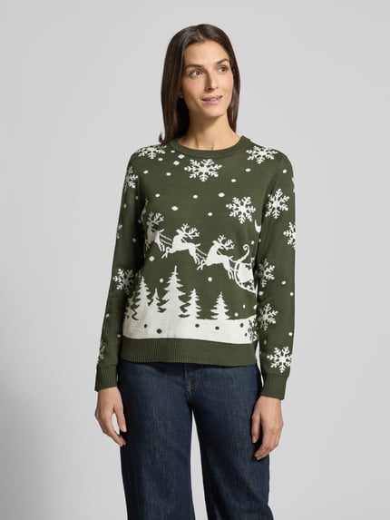 Kobiece modelka nosi Sweter z dzianiny z okrągłym dekoltem Modell 'SNOWI' od Vila, taliowany krój, prążkowane wykończenia, długość tyłu 59 cm, długość rękawów 62 cm, motyw śnieżynek i reniferów, widok z przodu, ujęcie całej sylwetki.