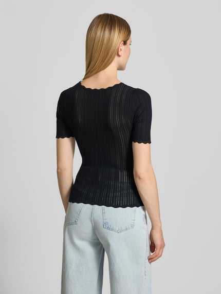 Frauenmodel trägt Slim Fit T-Shirt aus Viskose-Mix in Strick-Optik von Jake*s Casual, semitransparentes Schwarz, Ganzkörperansicht Rückansicht.