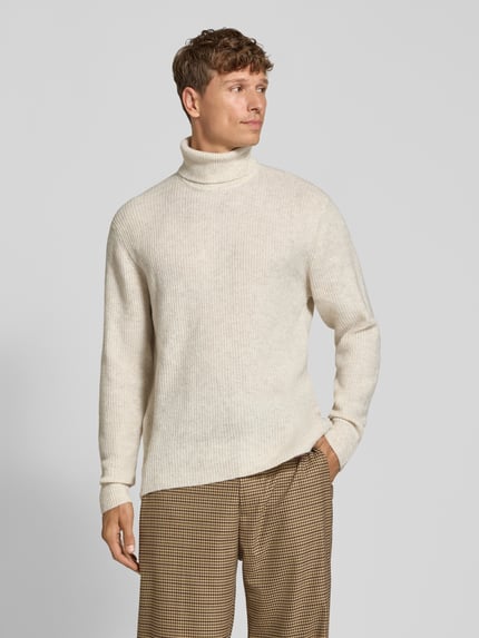 Männermodel trägt Strickpullover in Ripp-Optik mit Rollkragen von Lindbergh in Beige, kombiniert mit Karohose, Ganzkörperansicht von vorne. Herren Strickpullover Regular Fit, Rückenlänge 74 cm, Ärmellänge 62 cm.