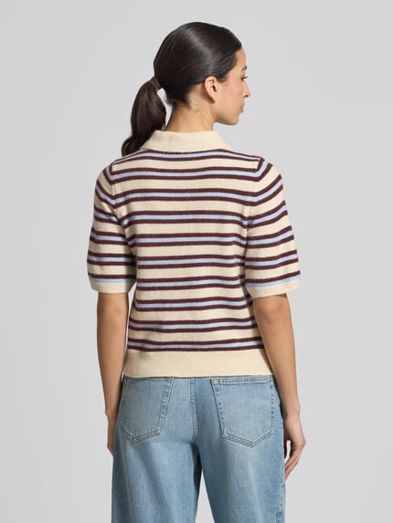 Frauenmodel trägt Regular Fit Strickpullover mit Woll-Anteil Modell 'CANNA' von Vero Moda, mehrfarbig gestreift, Rückansicht, Ganzkörperansicht.