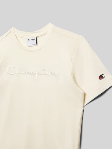 Produktfoto, cremefarbenes Regular Fit T-Shirt mit Logo-Stitching von Champion aus reiner Baumwolle, Rundhalsausschnitt, glatte Textur