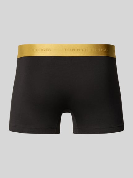 Produktfoto, Trunks mit elastischem Logo-Bund im 3er-Pack von Tommy Hilfiger in Schwarz mit goldfarbenem Logo-Bund, Jersey-Struktur, unifarben