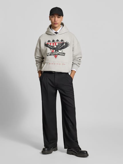 Männermodel trägt Oversized Hoodie aus katoenmix van RHUDE met labelprint, kangoeroezak, ribboorden, ruglengte maat M 64 cm, Ganzkörperansicht van voren