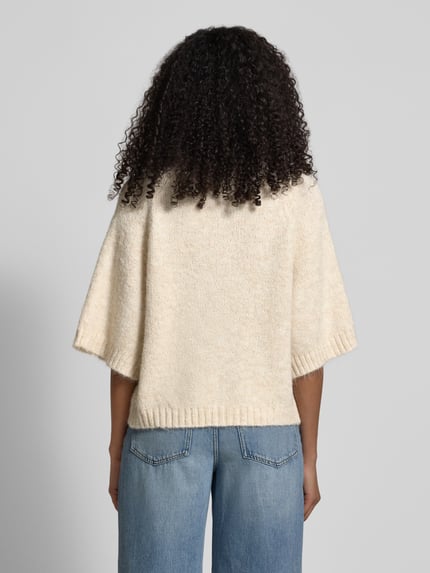 Männermodel trägt Kardigan rozpinany z krótkim rękawem Model 'Benutta Fluffy' od Neo Noir, mieszanka bawełny, krój relaxed fit, okrągły dekolt, zapięcie na guzik, długość tyłu w rozmiarze 36: 56 cm, długość rękawów: 41 cm, kremowy, gładka faktura, widoczna struktura dzianiny, pełny tył, widok z tyłu, Ganzkörperansicht Rückansicht.