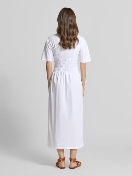 Frauenmodel trägt Midikleid mit Smok-Details von Jake*s Casual aus Reine Baumwolle, taillierter Schnitt, Ganzkörperansicht Rückansicht.