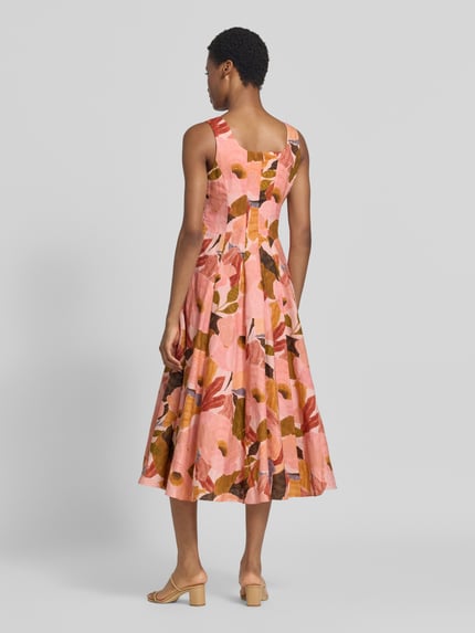 Modelka nosi sukienkę midi z mieszanki lnu i bawełny Ted Baker, model 'Shivana', kwiatowy nadruk na całej powierzchni, krój bez rękawów, taliowany krój, długość tyłu w rozmiarze 36: 110 cm, szerokość w rozmiarze 36: 44 cm, widok całej sylwetki z tyłu