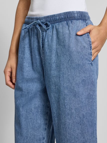 Frauenmodel trägt Wide Fit Jeans mit elastischem Bund Modell 'Enza' von Noisy May aus reiner Baumwolle, Nahaufnahme Oberkörper.