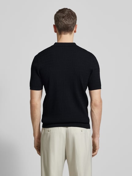 Männermodel trägt Regular Fit Poloshirt mit Seide-Anteil Modell 'Luxury' von Profuomo in Schwarz, Strickoptik, Rückenansicht ganzkörper
