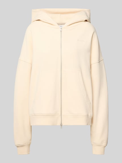 Produktfoto, Oversized Sweatjacke mit Zweiwege-Reißverschluss Modell 'Flower' von OH APRIL aus Reine Baumwolle mit Kapuze, Label-Stitching und Känguru-Tasche, cremefarben, glatte Textur.