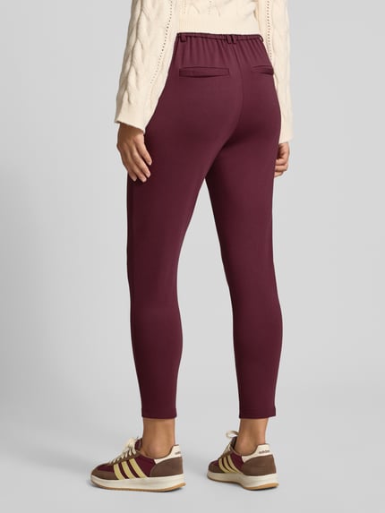 Frauenmodel trägt Gerade Hose mit Gürtelschlaufen Modell 'POPTRASH' von ONLY in Dunkelrot, strukturierte Oberfläche, Damen Gerade Hose von ONLY, Ganzkörperansicht Rückansicht.