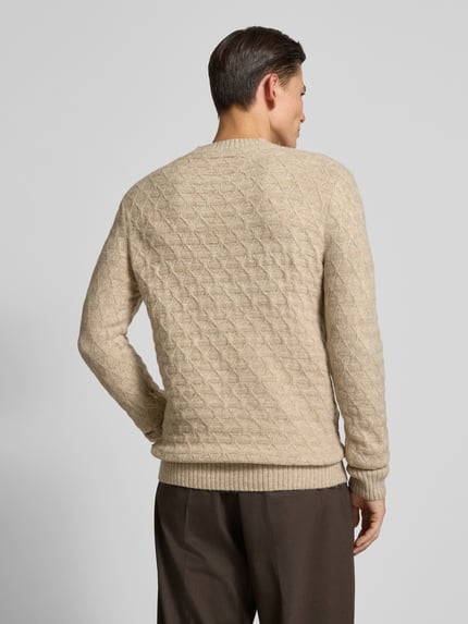 Męski model nosi Sweter z dzianiny z prążkowanymi wykończeniami model 'BLASIMON' od Jack & Jones Premium, kolor beżowy, mieszanka materiałów z dodatkiem wełny, krój regular fit, okrągły dekolt, długość tyłu 71 cm, długość rękawów 72 cm, tekstura geometryczna, widok całej sylwetki z tyłu.