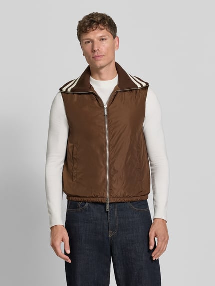 Männermodel trägt Weste mit Kontraststreifen von Dsquared2, braun mit Zweiwege-Reißverschluss und elastischem Bund, Ganzkörperansicht von vorne. Gerade Passform, Umlegekragen in Ripp-Optik, dezente Textur, Brustweite 56 cm, Rückenlänge 65 cm, Schulterbreite 45 cm.