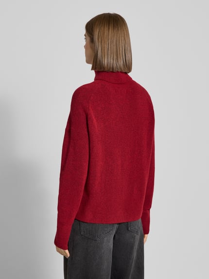 Frauenmodel trägt Regular Fit Rollkragenpullover aus Schurwoll-Mix von Marc O'Polo Denim in melierter Optik, langarm, Strickstruktur, Ganzkörperansicht Rückansicht.