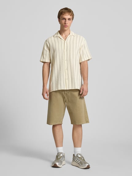 Männermodel trägt Regular Fit Freizeithemd mit Strukturmuster Modell 'COBA' von Jack & Jones in Beige mit Reverskragen und Knopfleiste, Baumwoll-Mix, Ganzkörperansicht von vorne.