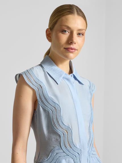Frauenmodel trägt Hemdblusenkleid aus Modal-Mix mit Spitze Modell 'COLE' von Copenhagen Muse in Hellblau, Nahaufnahme Oberkörper.