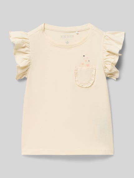 Produktfoto, Regular Fit T-Shirt mit Rüschenbesatz von Blue Seven, Kinder T-Shirt aus Reine Baumwolle, Rüschenbesatz, Brusttasche, Rückenlänge 38 cm bei Größe 116, cremefarben, weiche Textur