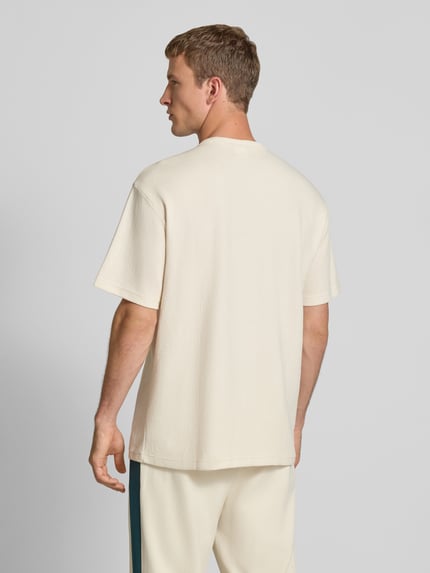 PUMA Performance Relaxed Fit T-Shirt mit Brusttasche Offwhite 5