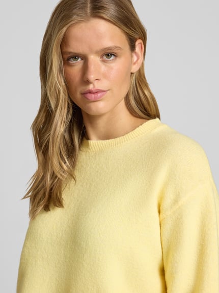 Vrouwenmodel draagt Regular Fit Pullover met Woll-Anteil Modell 'ALLY' van PIECES, lichtgeel, zachte textuur, Nahaufnahme Oberkörper