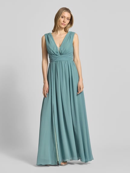 Frauenmodel trägt Maxikleid mit Taillenband und Drapierungen von TROYDEN COLLECTION aus Chiffon, taillierter Schnitt, V-Ausschnitt, Ganzkörperansicht von vorne. Rückenlänge bei Größe 36: 133 cm, Brustweite bei Größe 36: 32 cm.