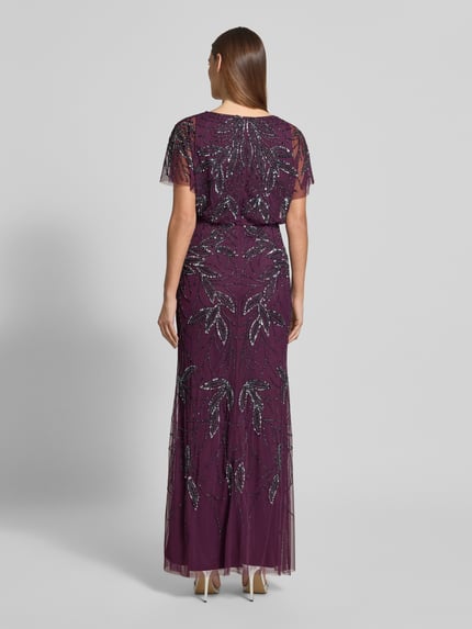 Frauenmodel trägt Abendkleid mit Perlen und Pailletten von Christian Berg Cocktail, Maxikleid in dunklem Lila mit Glitzerdetails, Ganzkörperansicht Rückansicht.