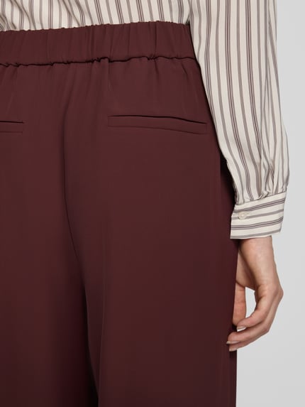 Kobieta nosi spodnie 'Wide Fit Hose mit Gesäßtaschen' od Jake*s Collection z elastycznej mieszanki materiałów, kieszenie z tyłu, detailaufnahme okolic pasa