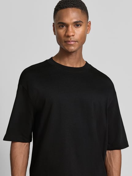 Männermodel trägt Regular Fit T-Shirt aus reiner Baumwolle Modell 'RELAXASPEN' von SELECTED HOMME, Optik: Unifarben, Nahaufnahme Oberkörper.