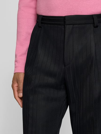 Männermodel trägt Regular Fit Anzughose aus Viskose-Mix Modell 'HESTEN' von HUGO in Schwarz mit Allover-Streifenmuster, Nahaufnahme Oberkörper.