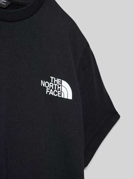 Produktfoto, Regular Fit T-Shirt mit Logo-Print von The North Face, Kinder T-Shirt in Schwarz, weißer Logo-Print, Rundhalsausschnitt, Statement-Print, Rückenlänge bei Größe M 51 cm