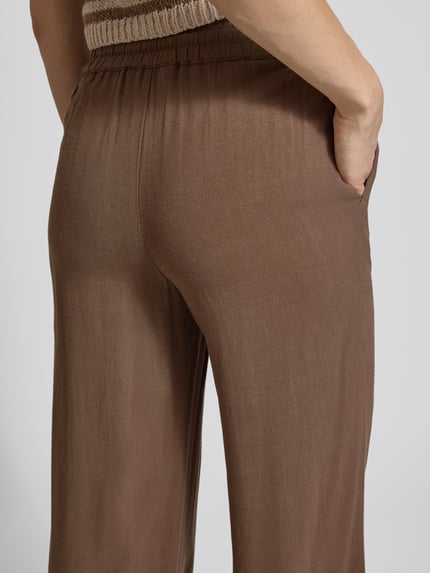 Frauenmodel trägt Regular Fit Weite Hose aus Viskose-Leinen-Mix Modell 'VIVA-GULIA' von Selected Femme, Optik: Unifarben, Flammgarn, seitliche Eingrifftaschen, elastischer Bundabschluss, Nahaufnahme Rückansicht.