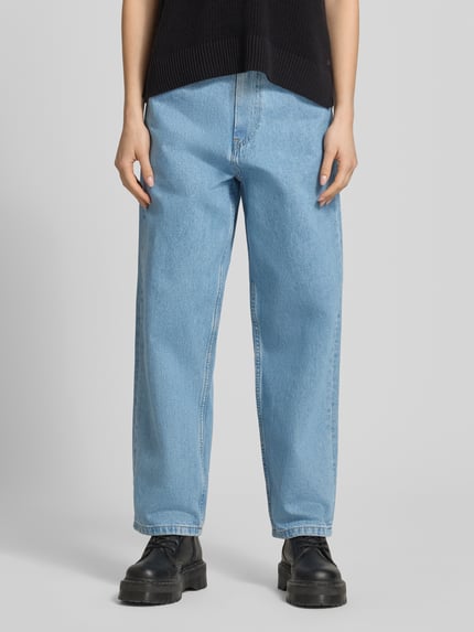 Frauenmodel trägt Wide Leg Jeans im 5-Pocket-Design Modell 'Brandon' von Carhartt Work In Progress aus Reine Baumwolle, hellblaue Farbe, Wide-Fit, Knopf- und Reißverschluss, Jeans-Optik, Ganzkörperansicht von vorne.