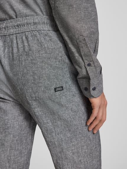 Männermodel trägt Hose aus Baumwoll-Leinen-Mix mit elastischem Bund von Blend, graue Struktur, Regular Fit, Detailaufnahme Rückansicht. Modell 'ABAN', Bundweite bei Größe M 39 cm, Innenbeinlänge 76 cm.