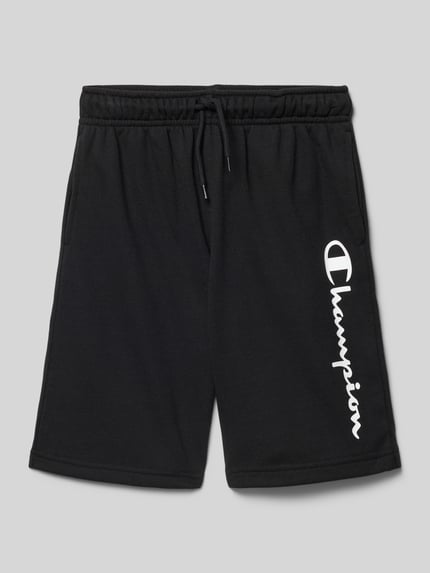 Produktfoto, Shorts mit Logo und elastischem Bund von CHAMPION, schwarze Kinder-Shorts aus Baumwoll-Mix, Relaxed Fit, weißer Logo-Print, elastischer Bund mit Tunnelzug, strukturierte Textur, Bundweite 31 cm, Innenbeinlänge 22 cm.