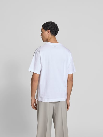 Mężczyznamodel nosi Regular Fit T-Shirt mit Statement-Print von Closed z czystej bawełny, krój regular fit, biały, krótkie rękawy, widok całej sylwetki z tyłu