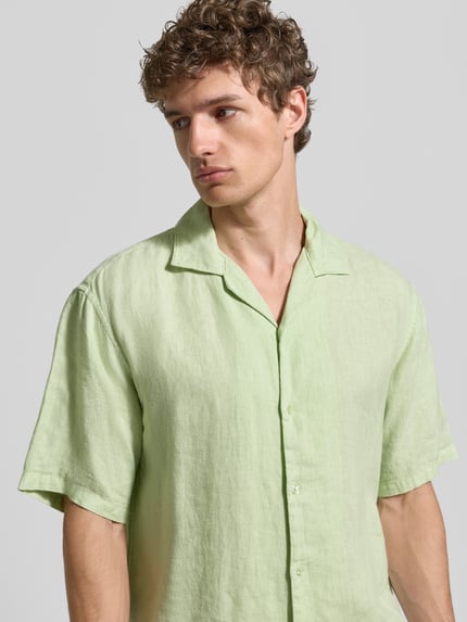 Männermodel trägt Regular Fit Leinenhemd mit Reverskragen von MCNEAL, Reines Leinen, Knopfleiste, Kurzärmelig, Nahaufnahme Oberkörper.