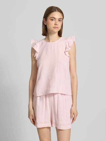 Frauenmodel trägt Regular Fit Top aus reiner Baumwolle Modell 'SASTINA' von Pieces in Rosa, Optik: Unifarben, Materialverarbeitung: Flammgarn, Nahaufnahme Oberkörper.