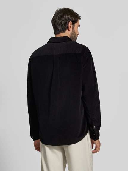 Männermodel trägt schwarzes Regular Fit Freizeithemd mit Label-Stitching von MCNEAL aus Cord, Nahaufnahme Rückansicht, reine Baumwolle.